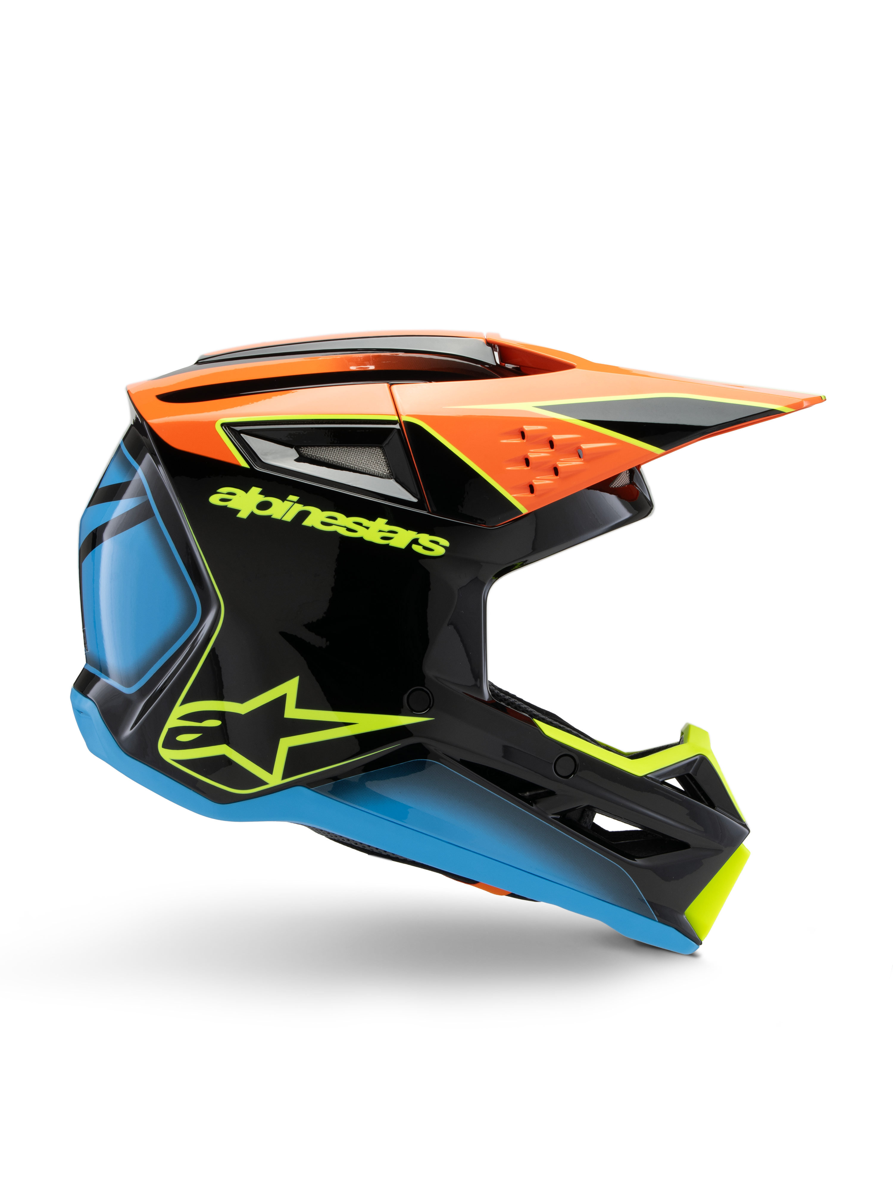 Casco Alpinestars S-M3 Youth Fray, casco de motocross, negro con detalles en naranja, azul y amarillo fluorescente, vista de perfil lateral que muestra el diseño aerodinámico, las ventilaciones y la visera angular, acabado brillante con logotipo amarillo llamativo.
