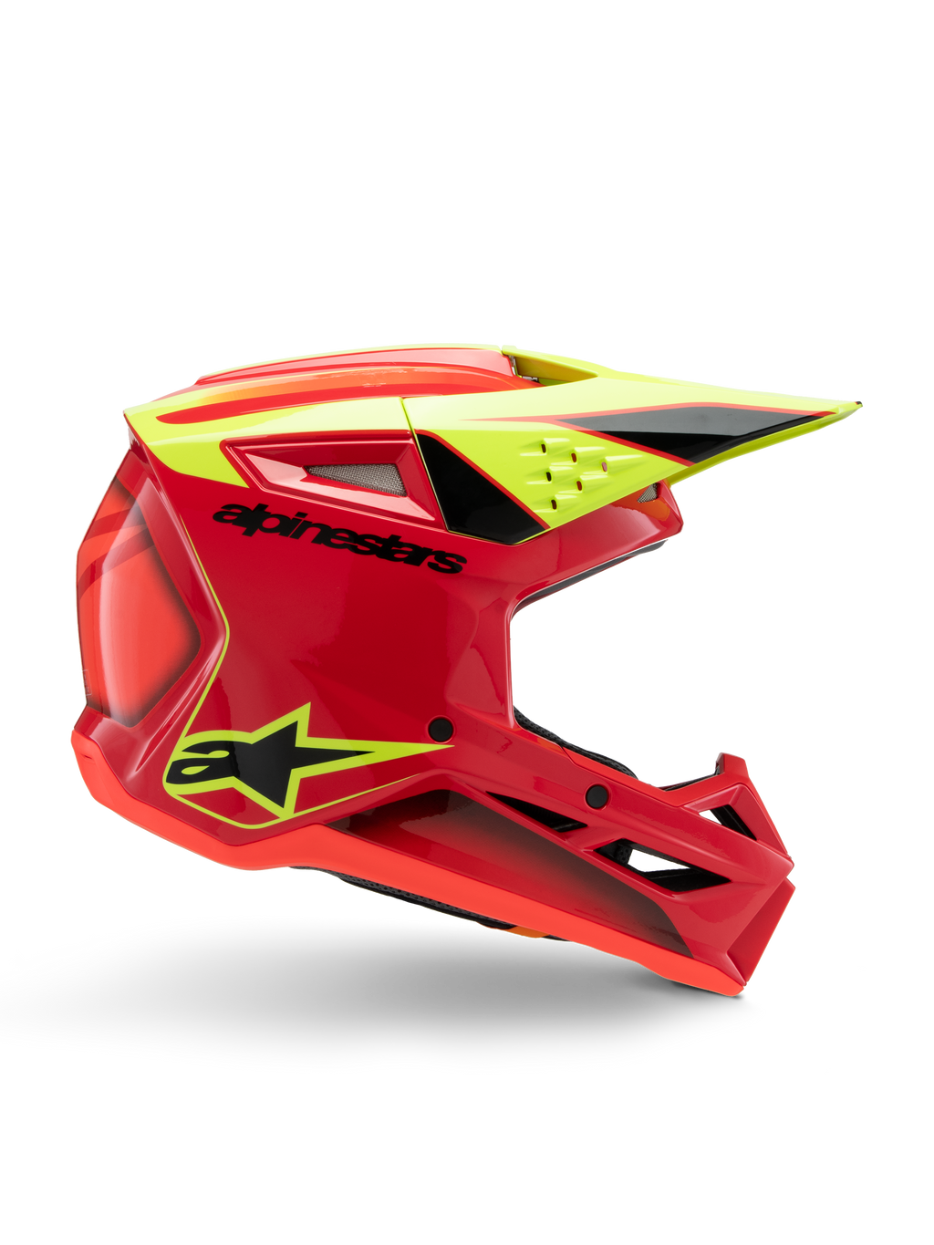 Casco Alpinestars S-M3 Youth Fray, casco de motocross, rojo, amarillo flúor y negro brillante, vista de perfil lateral que muestra un diseño aerodinámico con visera integrada y rejillas de ventilación prominentes, logotipo negro sobre una calota roja vibrante, optimizado para el rendimiento off-road juvenil