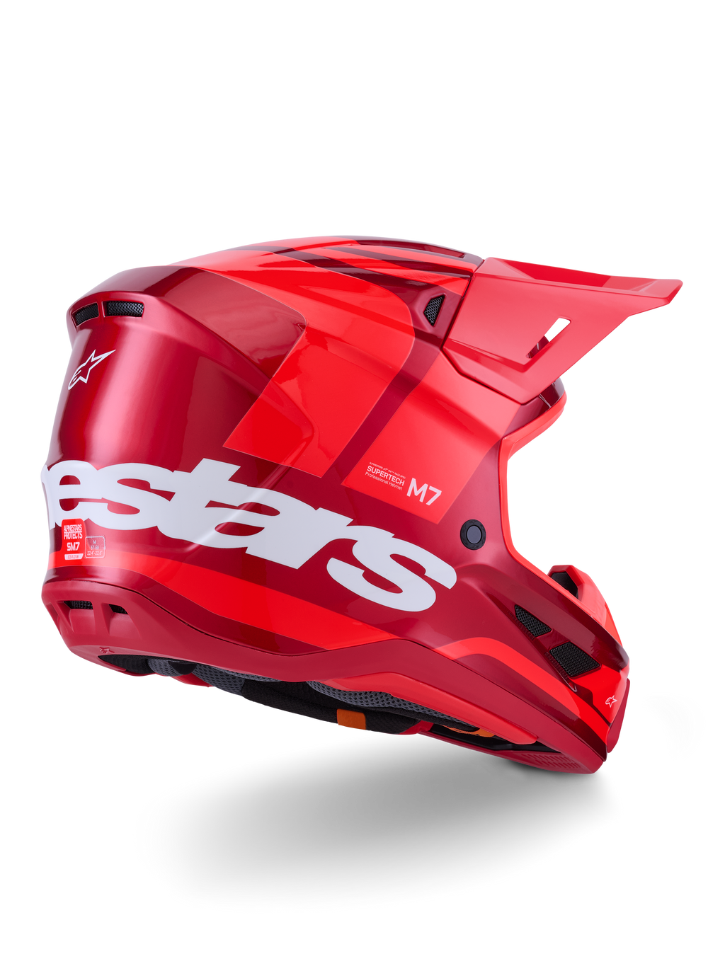 Casco Alpinestars S-M7 Core, casco de motocross, rojo brillante con un gran logotipo blanco de Alpinestars en el lateral, calota aerodinámica, puertos de ventilación integrados y visera protectora, vista posterior 3/4