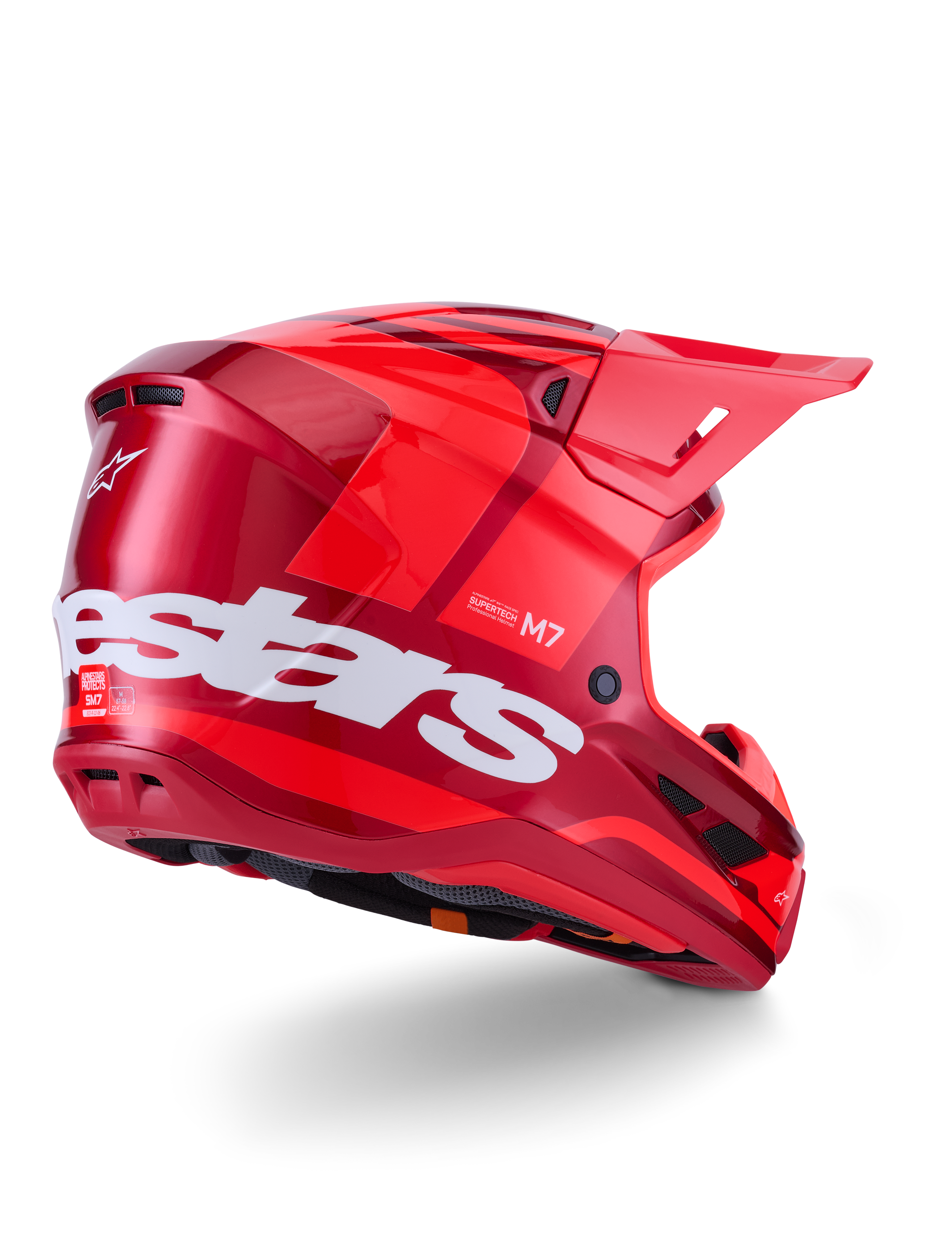 Casco Alpinestars S-M7 Core, casco de motocross, rojo brillante con un gran logotipo blanco de Alpinestars en el lateral, calota aerodinámica, puertos de ventilación integrados y visera protectora, vista posterior 3/4