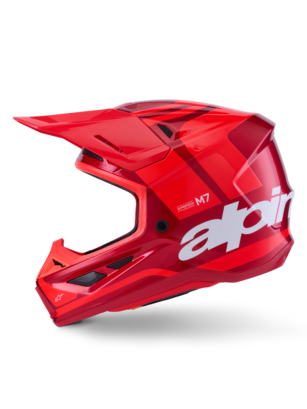 Casco Alpinestars S-M7 Core, color rojo brillante con acentos geométricos, casco de motocross en vista de perfil lateral, calota aerodinámica con puertos de ventilación y logotipos blancos, equipo de competición off-road de alto rendimiento