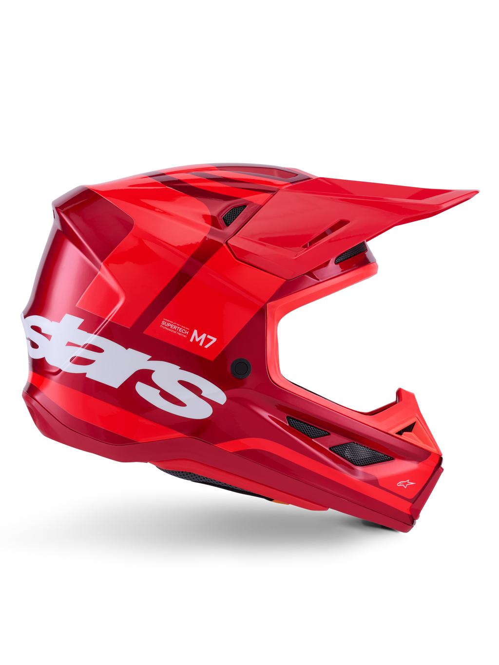Casco Alpinestars S-M7 Core, casco de motocross, rojo brillante con detalles en rojo oscuro y logotipos en blanco, vista lateral con un gran logotipo de estrellas en blanco, calota aerodinámica con puertos de ventilación de malla y una visera prominente