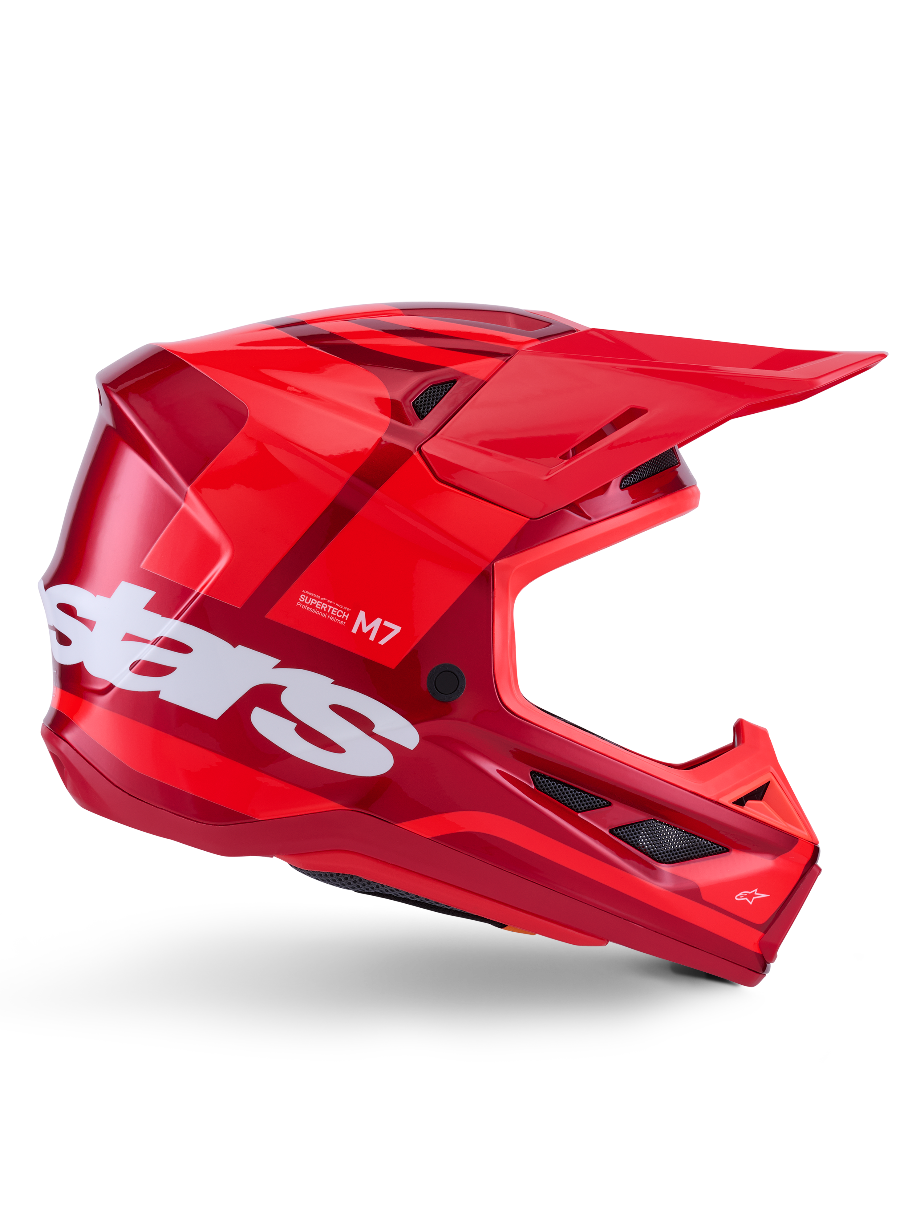 Casco Alpinestars S-M7 Core, casco de motocross, rojo brillante con detalles en rojo oscuro y logotipos en blanco, vista lateral con un gran logotipo de estrellas en blanco, calota aerodinámica con puertos de ventilación de malla y una visera prominente