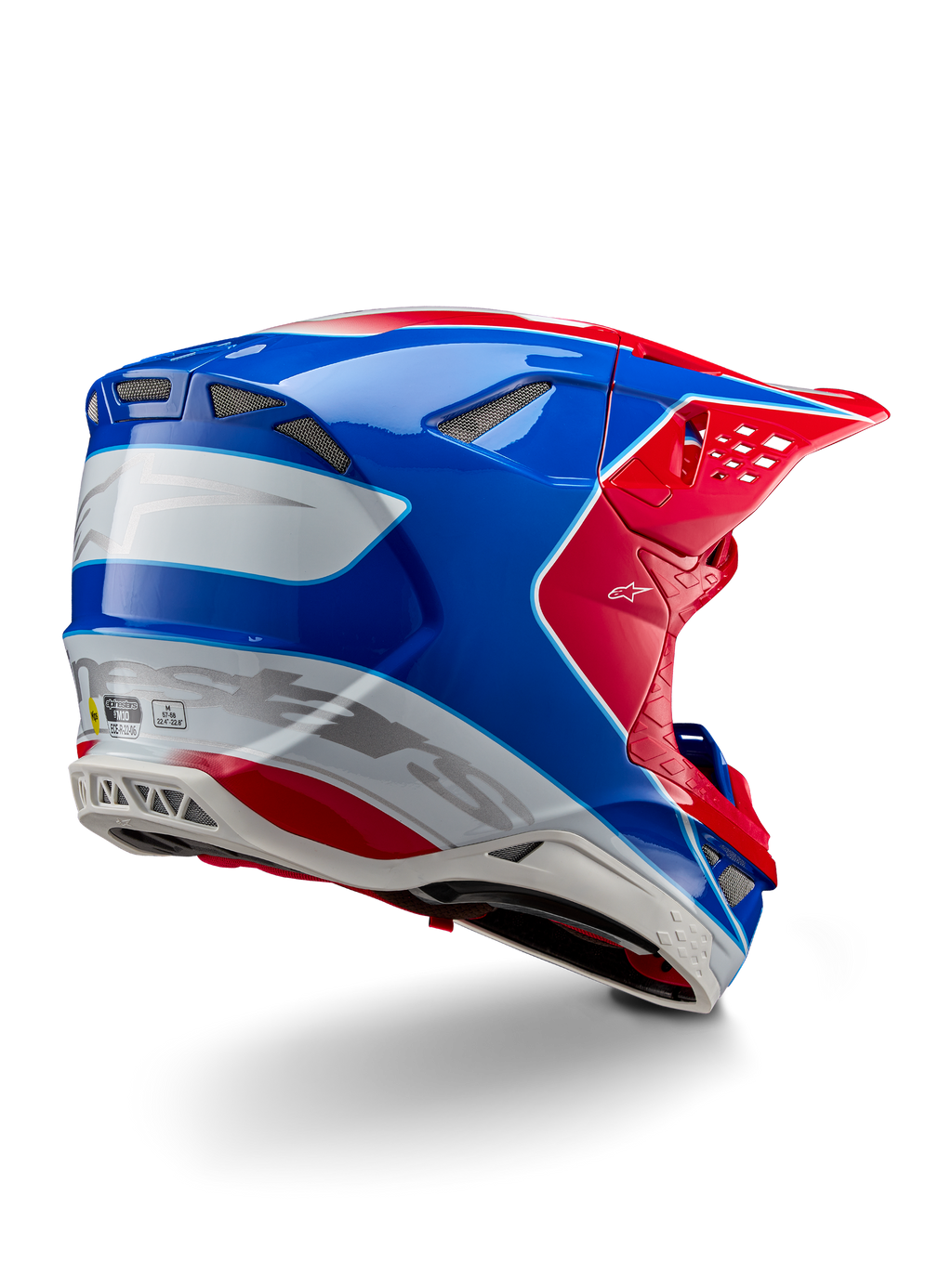 Casco Alpinestars Supertech M10 Aeon ECE 22.06, casco de motocross, rojo brillante, azul y blanco brillante, vista lateral trasera con un perfil aerodinámico, logotipos de Alpinestars en plateado y puertos de ventilación integrados.