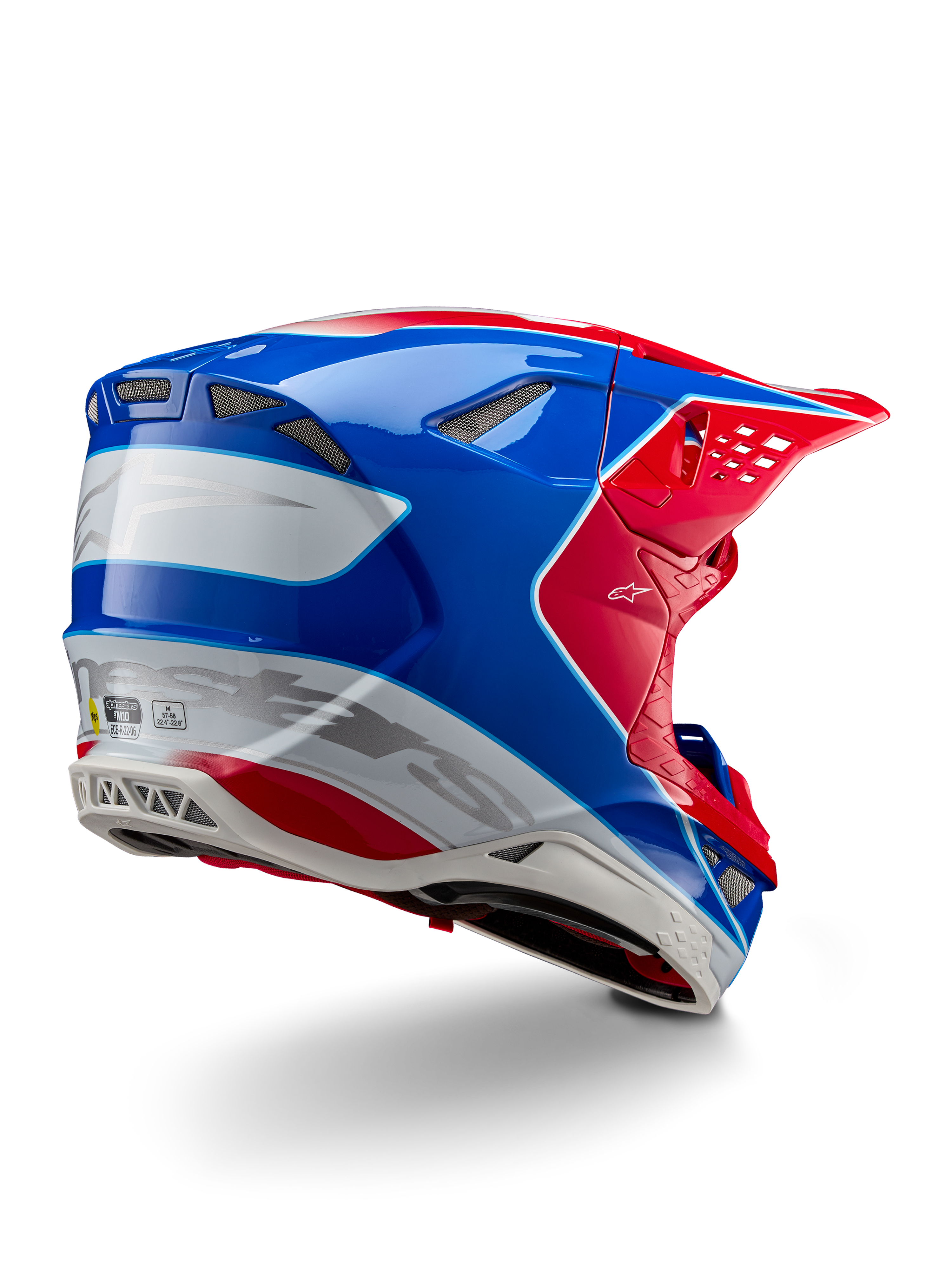 Casco Alpinestars Supertech M10 Aeon ECE 22.06, casco de motocross, rojo brillante, azul y blanco brillante, vista lateral trasera con un perfil aerodinámico, logotipos de Alpinestars en plateado y puertos de ventilación integrados.