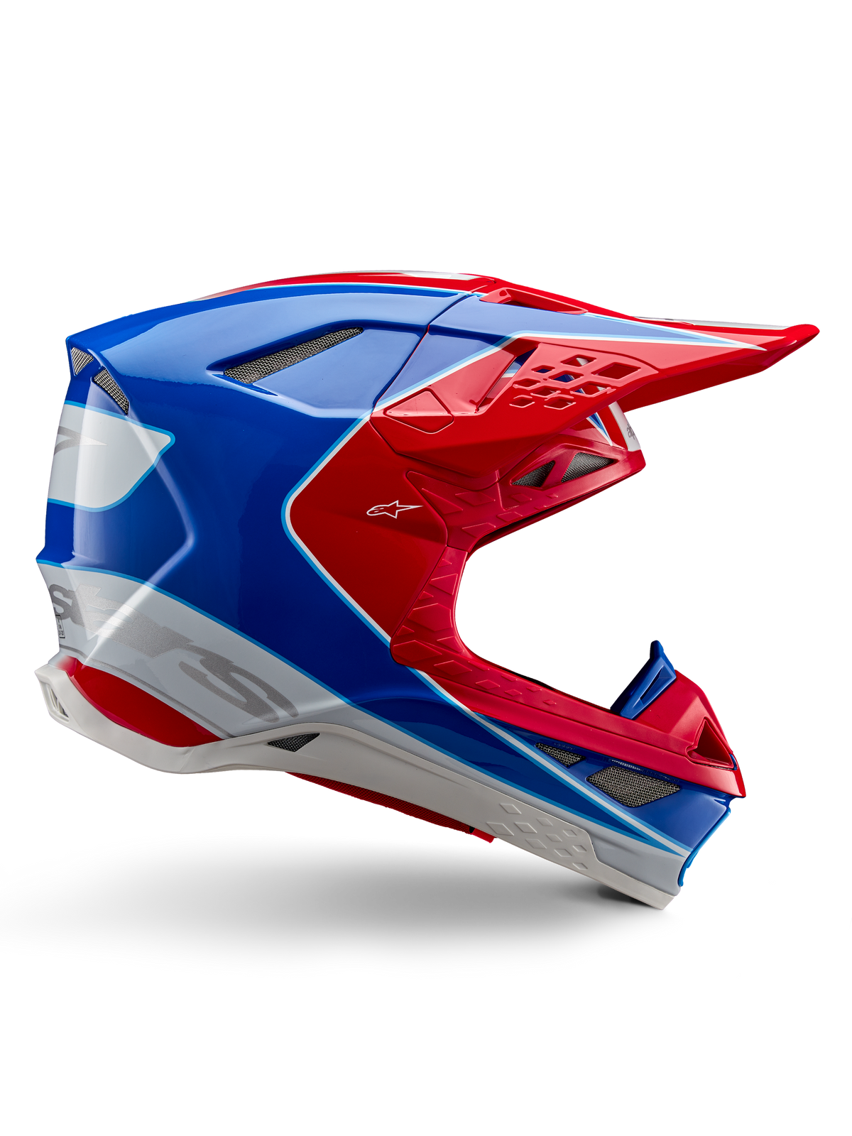 Casco Alpinestars Supertech M10 Aeon, casco de motocross, rojo brillante, azul y blanco, acabado brillante, perfil lateral aerodinámico con múltiples rejillas de ventilación cubiertas de malla, contornos angulares y visera