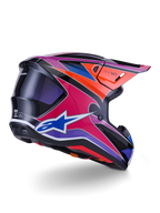 Casco Alpinestars S-M7 Fuse, casco de motocross, acabado brillante en azul, púrpura y rosa con detalles en naranja y negro, vista trasera en tres cuartos que muestra la calota aerodinámica, la visera y los puertos de ventilación, protección profesional para carreras off-road