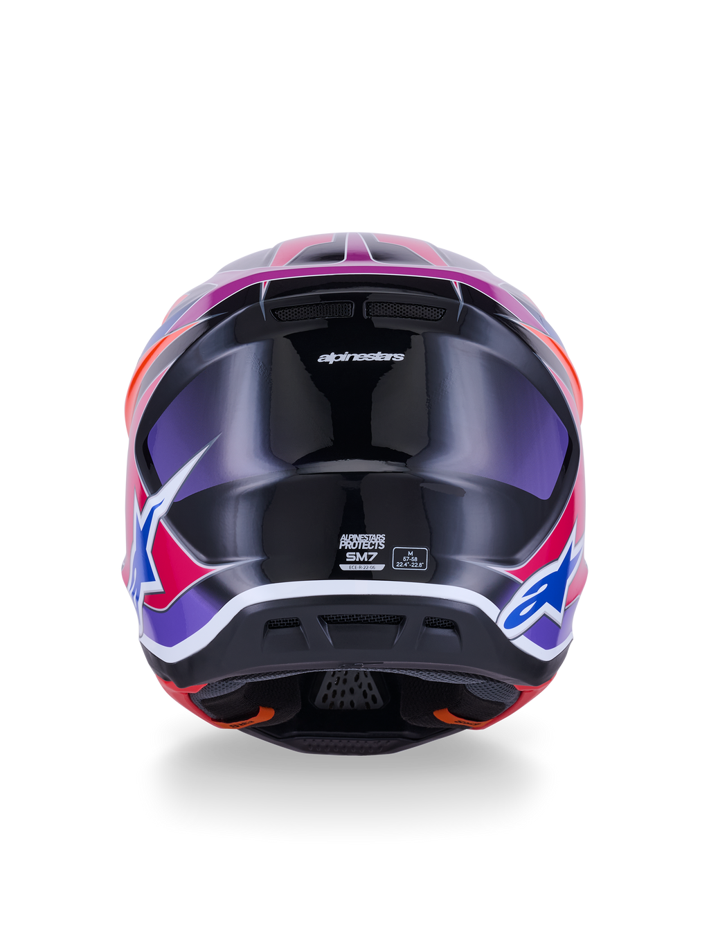 Casco Alpinestars S-M7 Fuse, casco de motocross, vista trasera, azul púrpura rosa brillante, gráficos vibrantes en rosa y púrpura sobre una calota negra brillante, con puertos de ventilación y etiqueta de certificación ECE 22.06