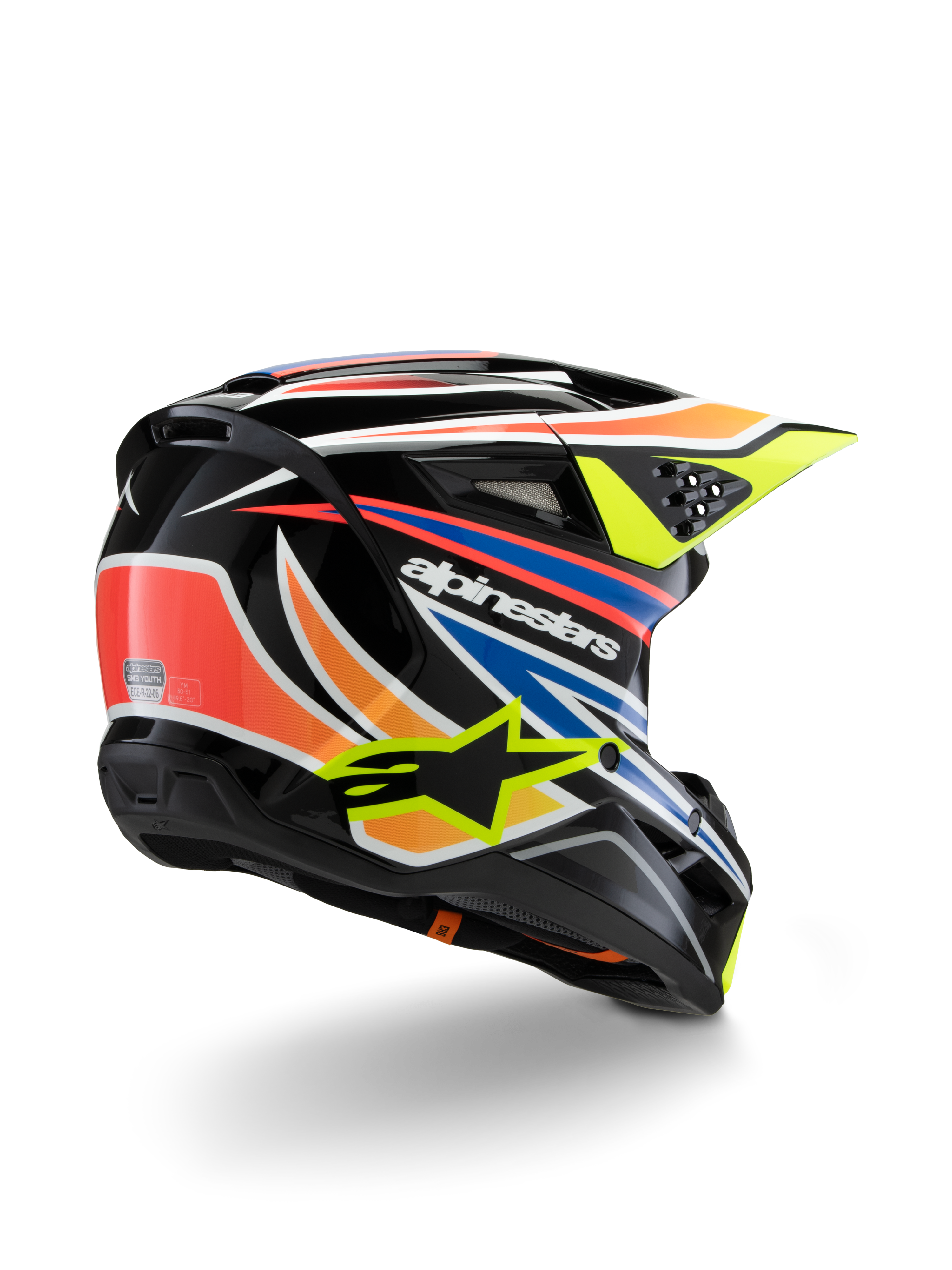 Alpinestars S-M3 Juvenil Wurx, casco de motocross para jóvenes, negro con detalles en naranja vibrante, rojo, azul y amarillo fluorescente, vista trasera en tres cuartos que muestra la carcasa aerodinámica y los orificios de ventilación, acabado brillante con la marca Alpinestars destacada.