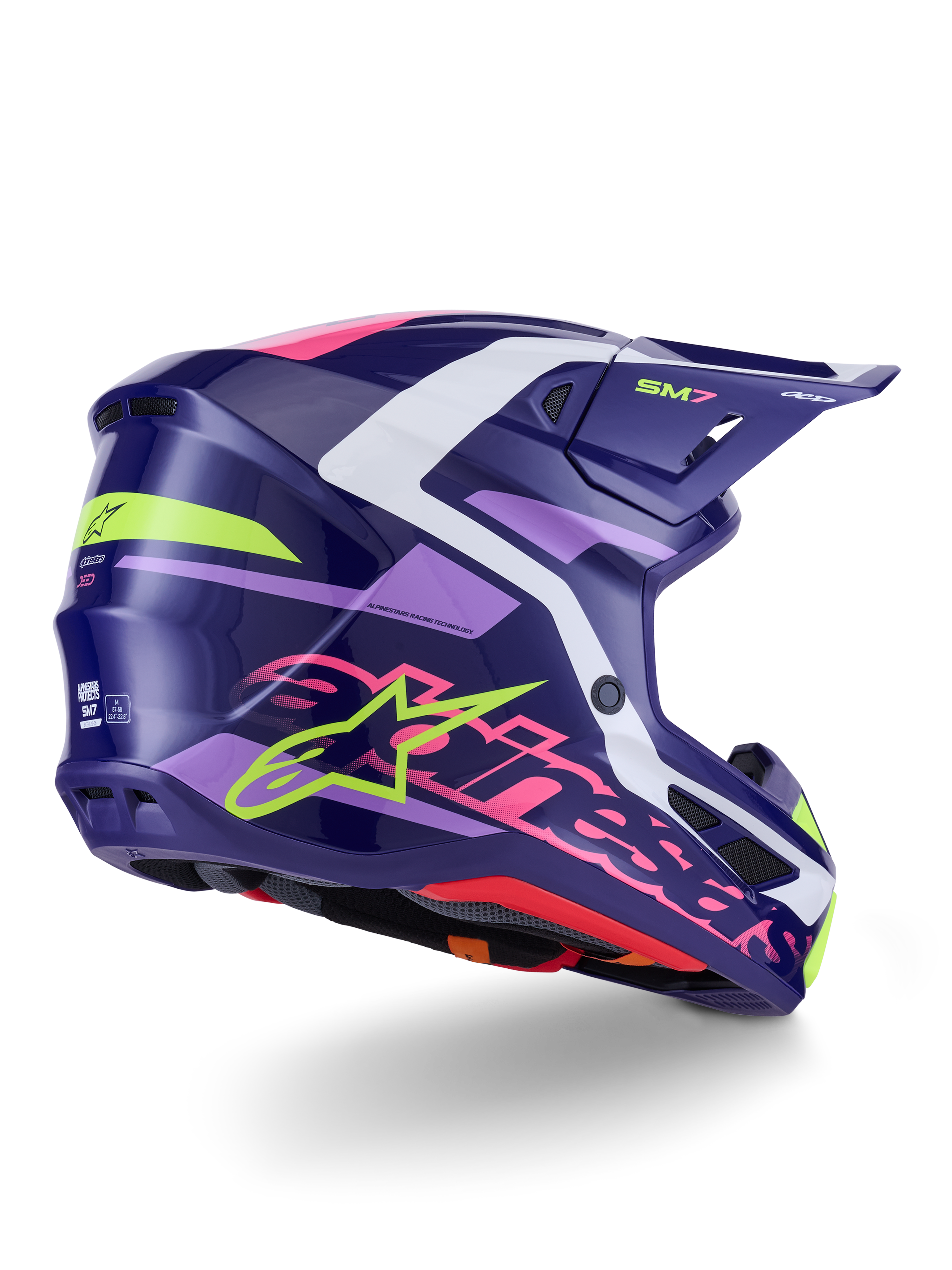 Casco Alpinestars S-M7 Deed, casco de motocross, púrpura y rosa brillante, vista lateral-trasera con detalles en blanco y verde lima, logotipo de la estrella y nombre de la marca Alpinestars en rosa llamativo, diseño de carcasa de composite aerodinámico para rendimiento off-road