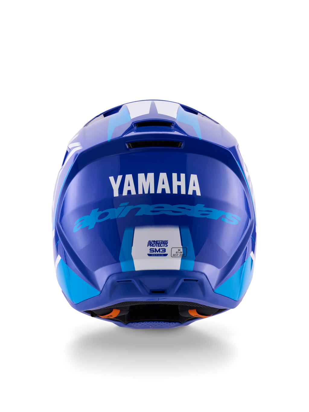 Casco Alpinestars Yamaha S-M3, casco de motocross, azul y blanco brillante, vista trasera que muestra el logotipo blanco de YAMAHA y la inscripción azul de Alpinestars, acabado brillante con puertos de ventilación y etiquetas de certificación de seguridad visibles.