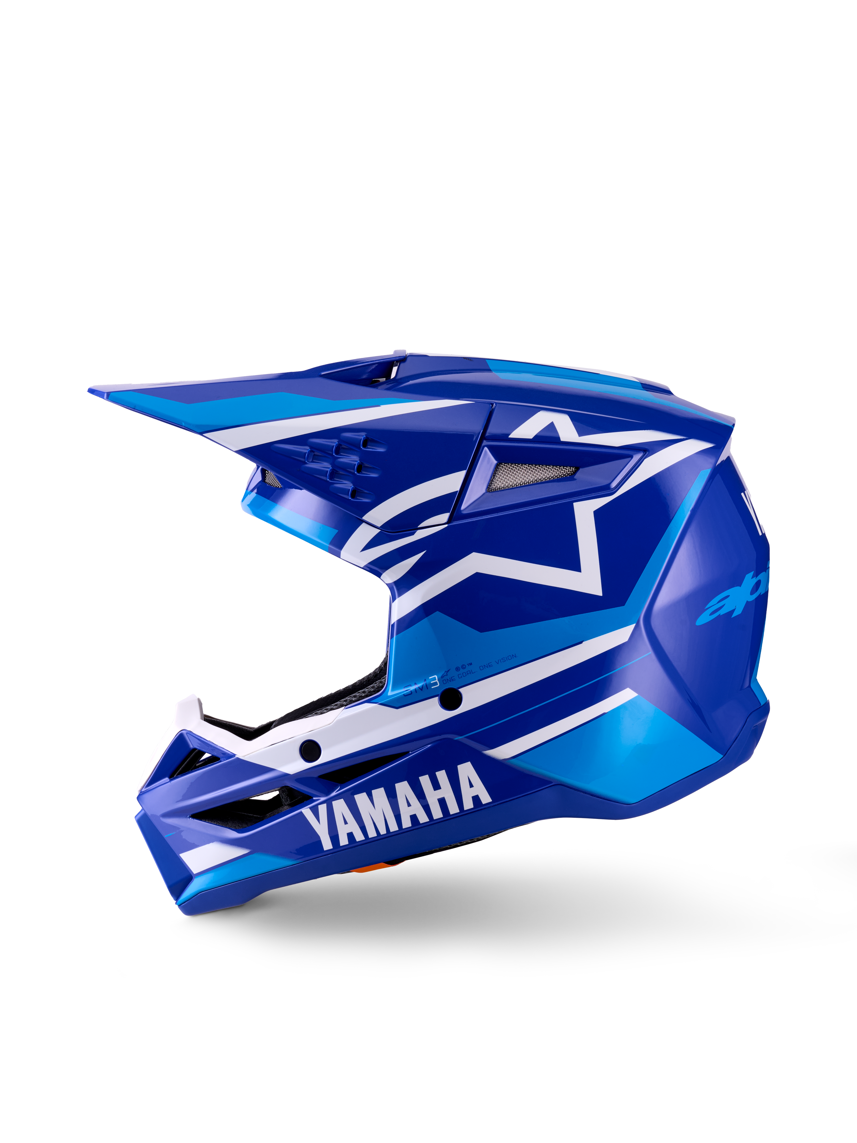 Casco de Motocross Yamaha S-M3 Juvenil, azul y blanco brillante, vista de perfil lateral, con marca Yamaha destacada en la mentonera y logo de la estrella de Alpinestars, calota aerodinámica con múltiples puertos de ventilación y visera integrada.