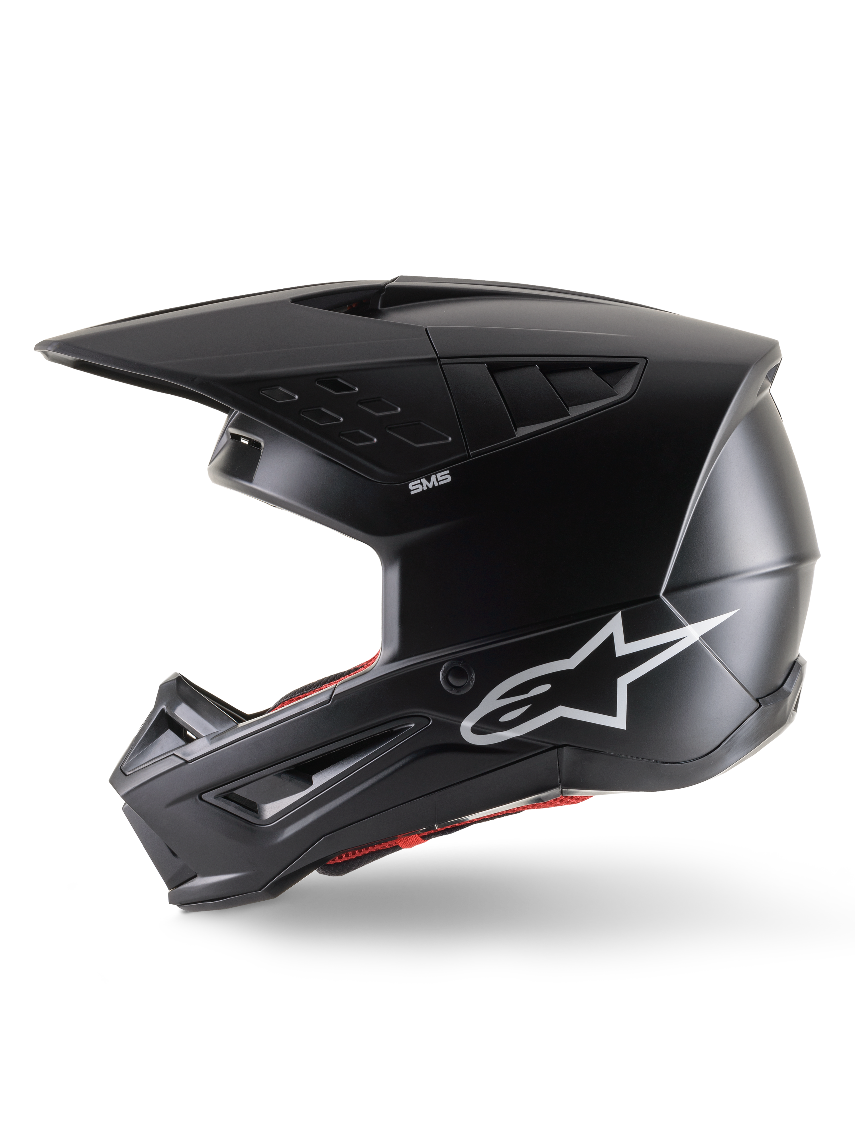 Alpinestars S-M5 Solid Helmet ECE 22.06, Motocross Helmet, Black Matt, side profile view featuring a sleek matte finish, white Alpinestars logo on the side, red interior padding, and aerodynamic shell with integrated ventilation ports