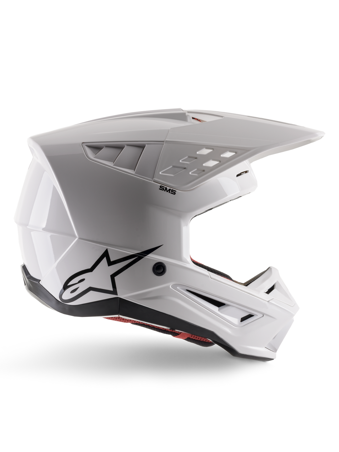 Alpinestars S-M5 Solid Helmet ECE 22.06, casco de motocross, blanco brillante, perfil lateral con diseño aerodinámico angular, visera prominente, ventilaciones integradas, logotipo negro de Astars en la parte trasera y acolchado interior rojo visible