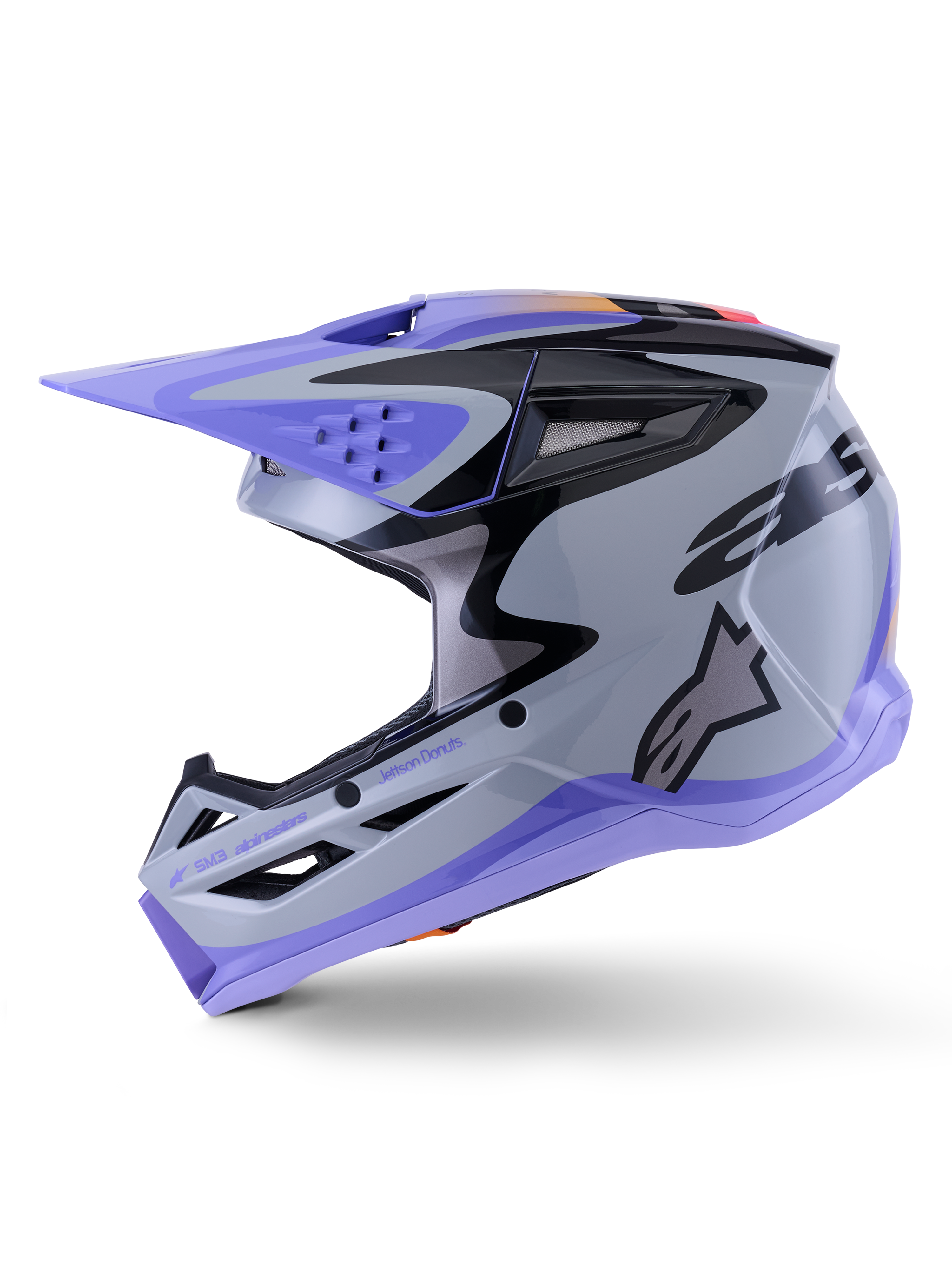 Casco Alpinestars S-M3 Jettson, casco de motocross, gris, púrpura y negro brillante, vista de perfil lateral con gráficos estilizados y visera ajustable, incluye múltiples puertos de ventilación y marca Alpinestars, protección todoterreno de alto rendimiento
