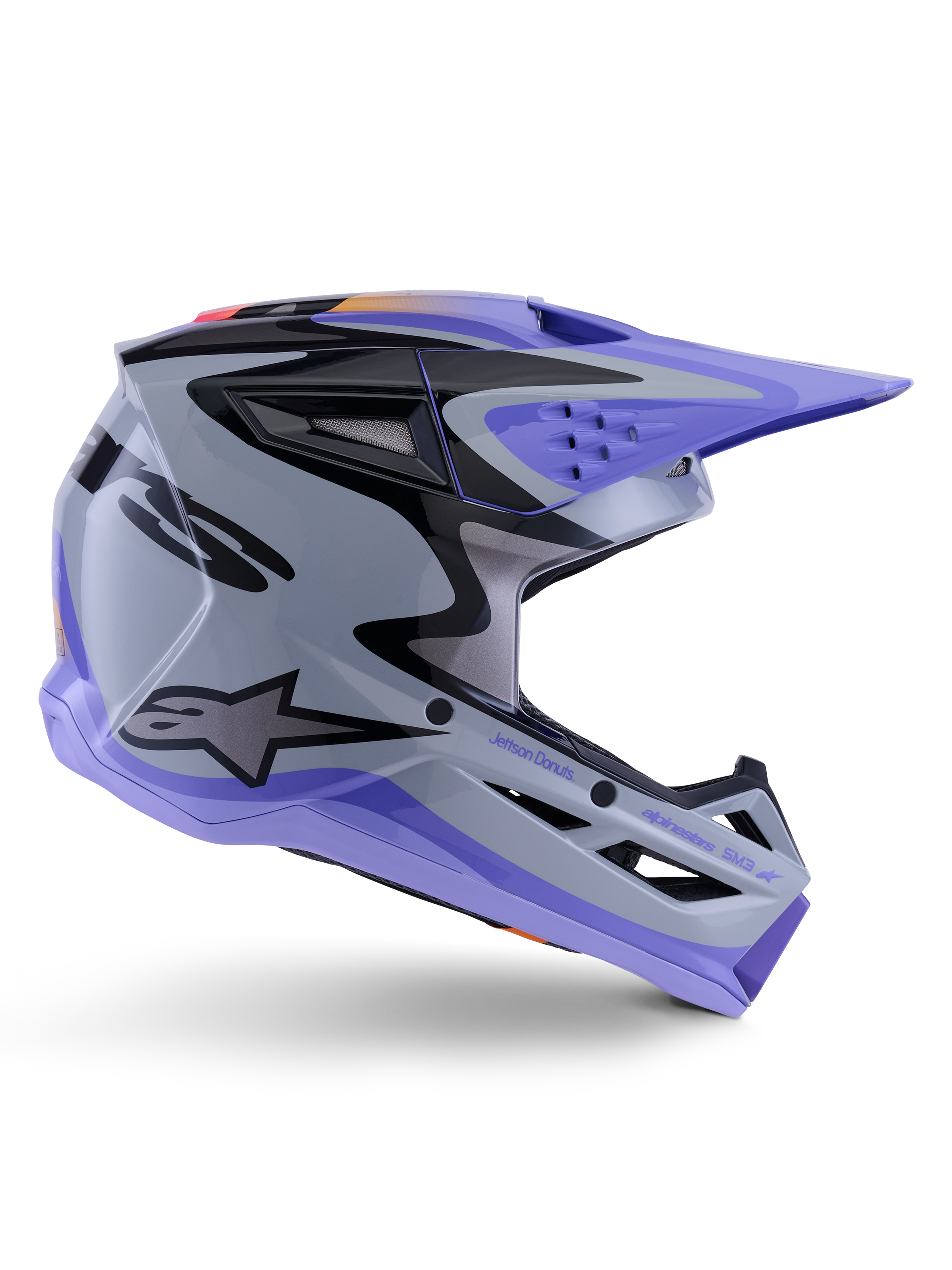 Casco juvenil Alpinestars S-M3 Jettson, casco de motocross, gris, morado y negro brillante, perfil lateral con gráficos angulares definidos y marca 'Jettson Donuts', diseño de calota aerodinámica con puertos de ventilación y logotipo de Alpinestars, equipo de protección off-road juvenil de alto rendimiento