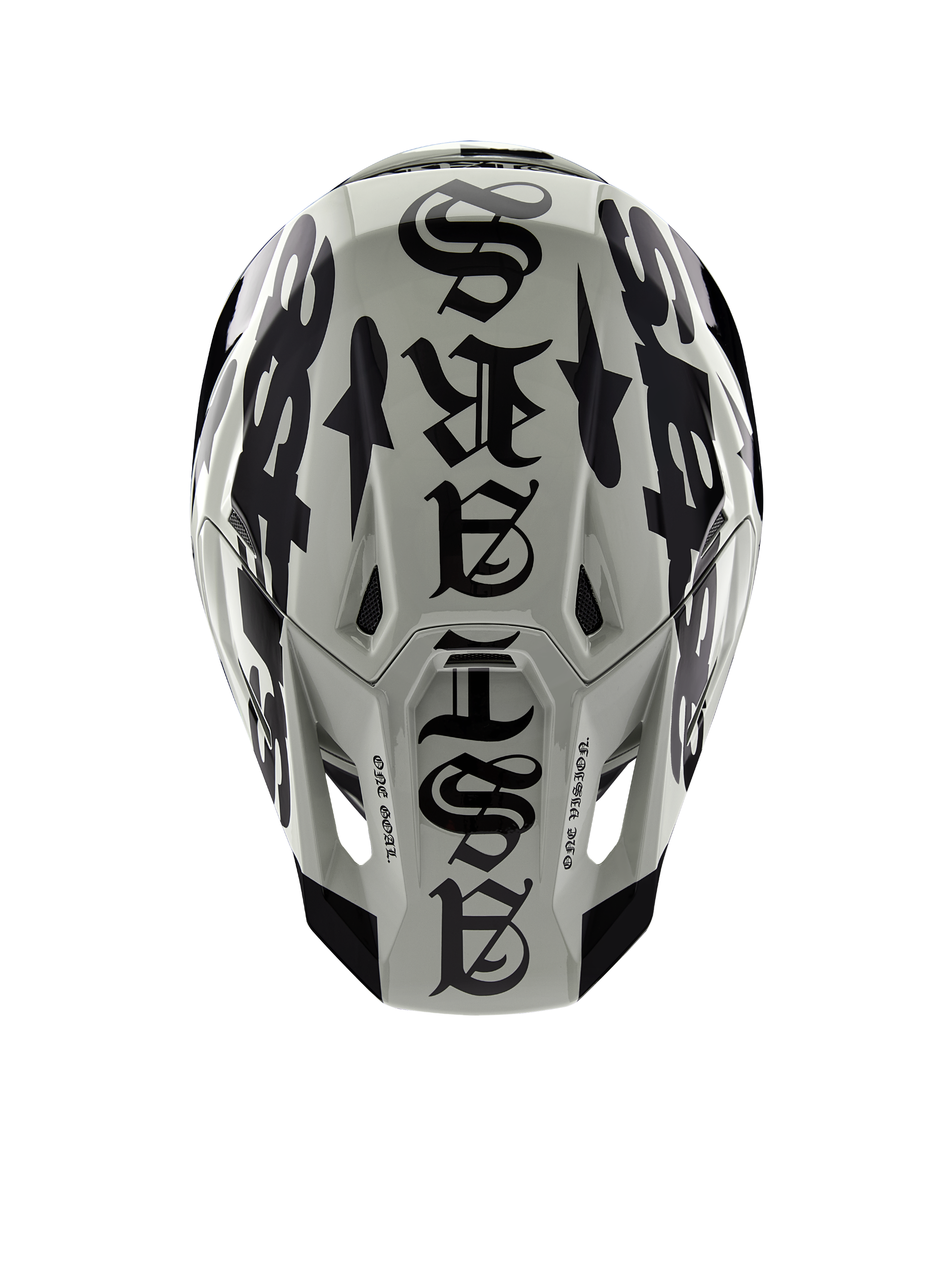 Casco Alpinestars Edición Limitada S-M7 Wolf Dust, vista superior, acabado Dune y negro brillante, con tipografía audaz de estilo gótico en la parte superior y detalles de 'One Goal One Vision', protección profesional para motocross