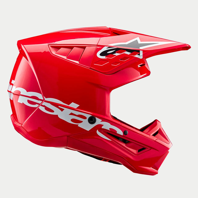 Casco Alpinestars S-M5 Corp ECE, casco de motocross, rojo brillante con acabado brillante, vista de perfil lateral que muestra un gran logotipo blanco de Alpinestars en la carcasa inferior, visera aerodinámica ventilada con logotipo de estrella y acabado de alto brillo para protección en carreras off-road