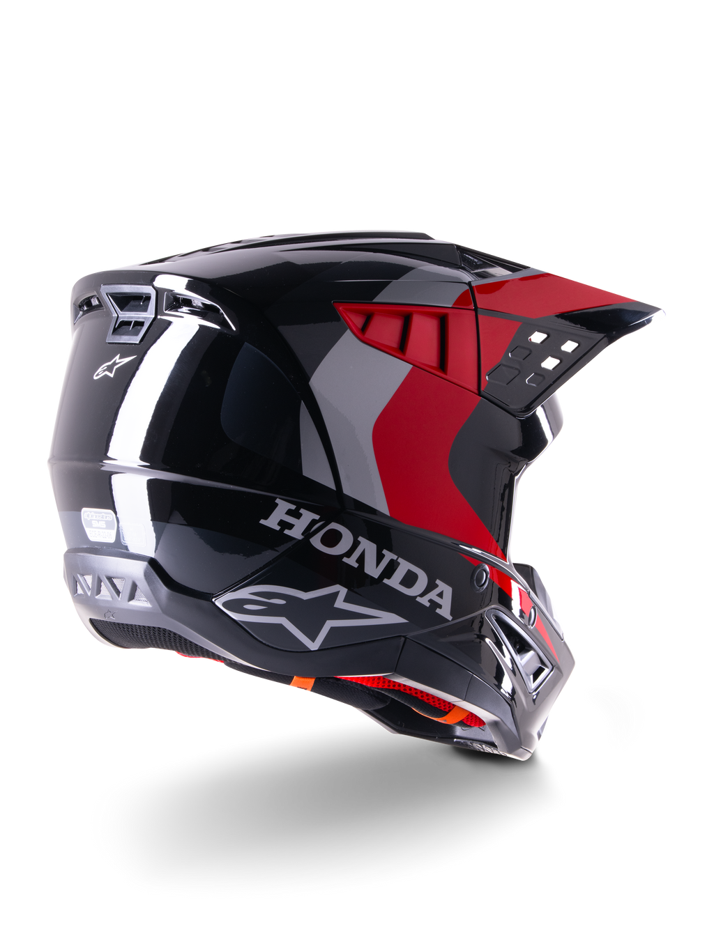 Alpinestars Honda S-M5 Helmet ECE, casco de motocross, negro y rojo brillante, vista trasera en tres cuartos con la marca Honda y logotipos de Alpinestars, acabado brillante con acentos gráficos en rojo y gris, diseñado para protección todoterreno