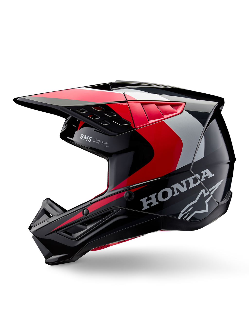 Casco Alpinestars Honda S-M5, casco de motocross, negro, rojo y plateado brillante, vista de perfil lateral con marca Honda y logotipo de estrella de Alpinestars, diseño aerodinámico con visera integrada y puertos de ventilación para rendimiento off-road