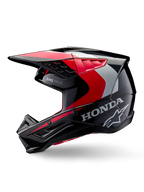 Casco Alpinestars Honda S-M5, casco de motocross, negro, rojo y plateado brillante, vista de perfil lateral con marca Honda y logotipo de estrella de Alpinestars, diseño aerodinámico con visera integrada y puertos de ventilación para rendimiento off-road