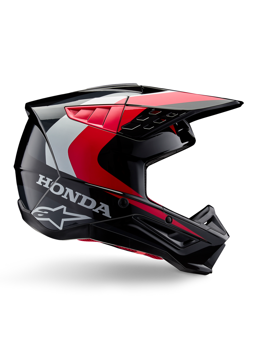 Casco Honda S-M5, casco de motocross, negro y rojo brillante con detalles en blanco y plata, vista lateral con los logotipos de Honda y Alpinestars, diseño aerodinámico con visera y múltiples puertos de ventilación, equipo de protección profesional para todoterreno