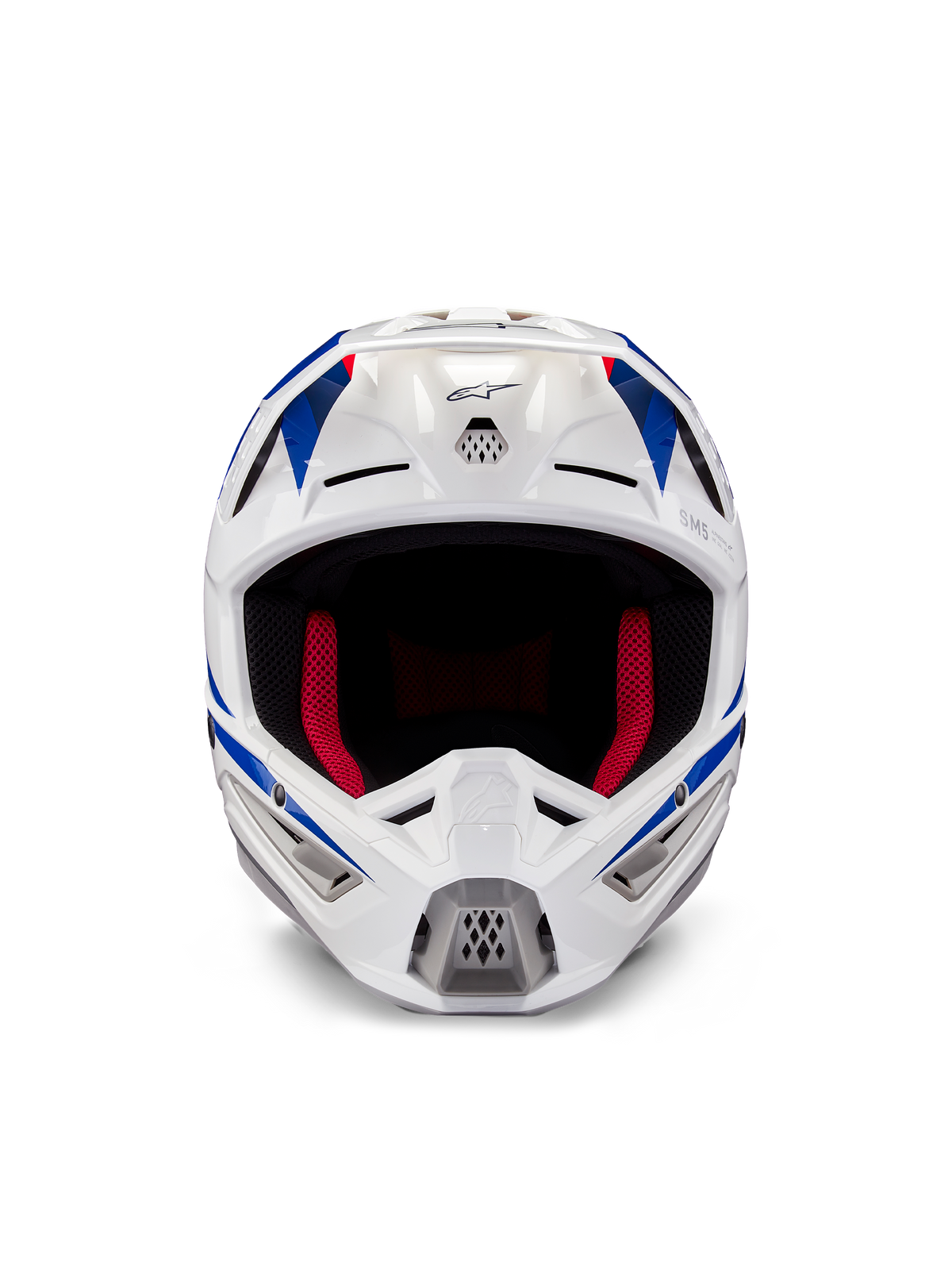 Casco Alpinestars Honda S-M5 ECE, casco de motocross, blanco, azul y rojo brillante, vista frontal que muestra los puertos de ventilación y el acolchado interior rojo, diseño aerodinámico para protección en carreras todoterreno