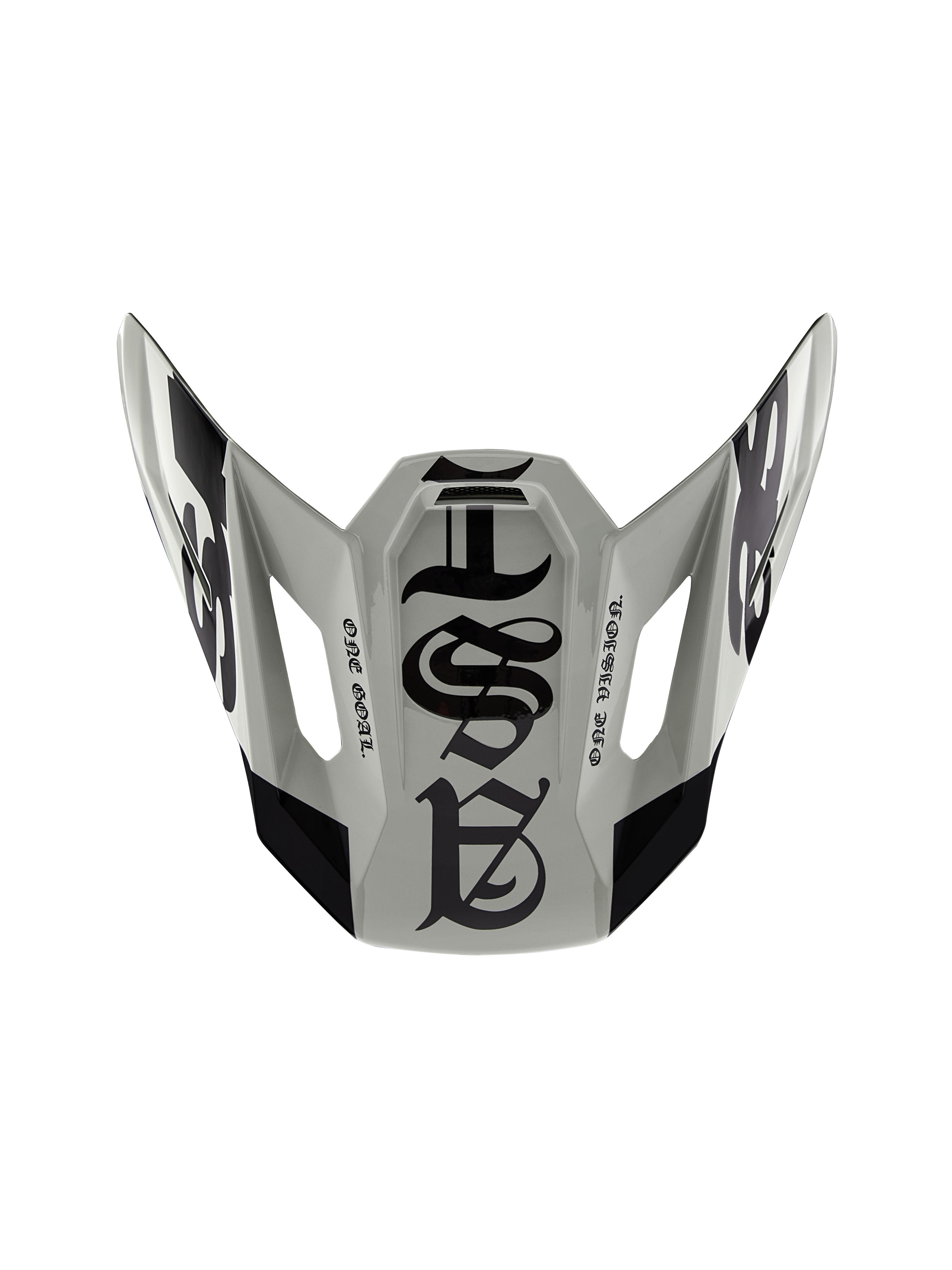 Visera Alpinestars S-M7 Wolf Dust 22.06 de edición limitada, visera de repuesto para casco de motocross, color duna y negro brillante, con gráficos de estilo gótico y el texto 'ONE GOAL' 'ONE VISION', diseño aerodinámico para carreras off-road