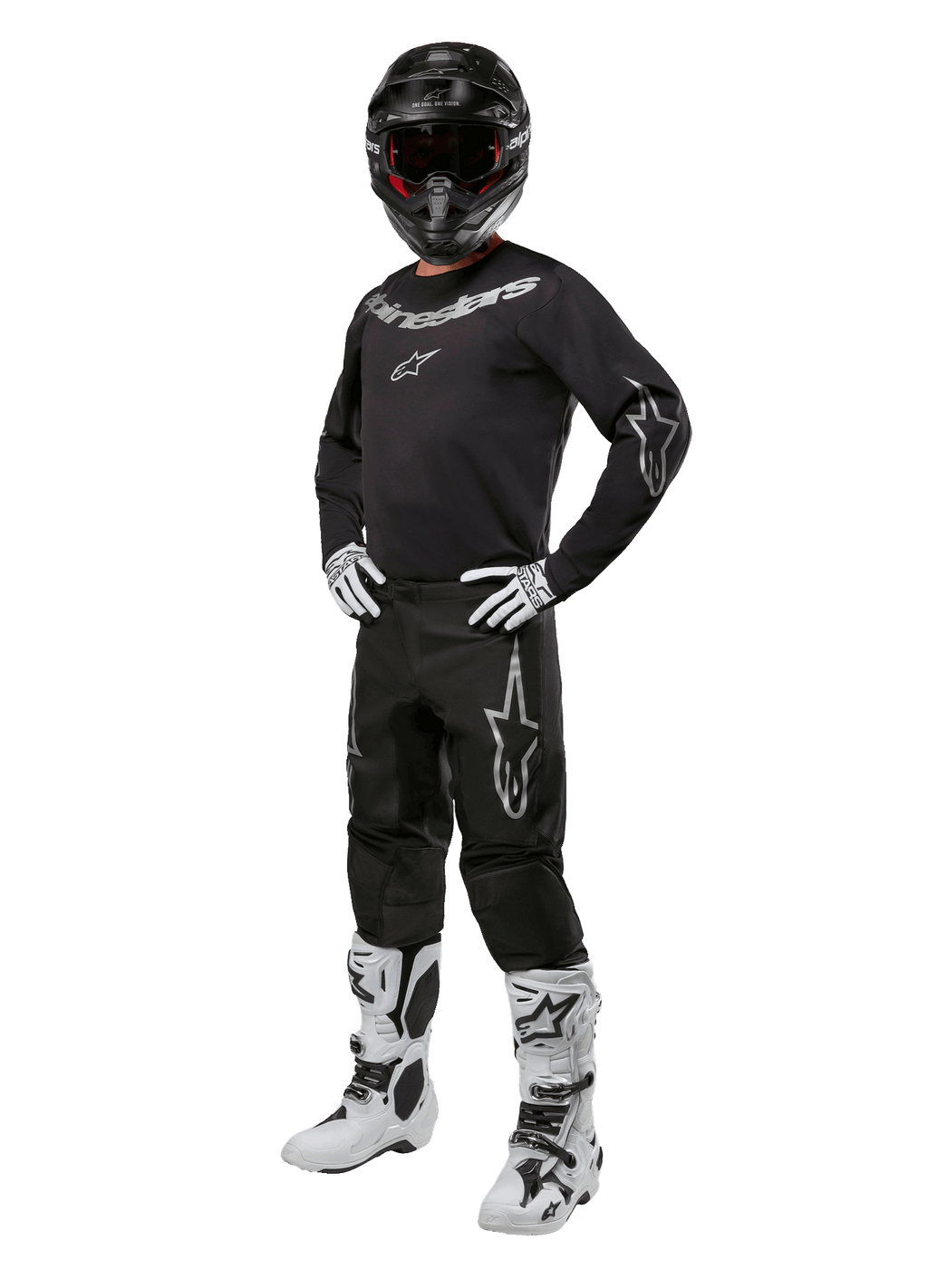 Alpinestars 2024 Fluid Graphite Gear Set, equipo completo de carreras de motocross, negro con logotipos grises y blancos, con jersey y pantalones usados con casco negro a juego, guantes y botas blancas y negras, diseñado para protección todoterreno