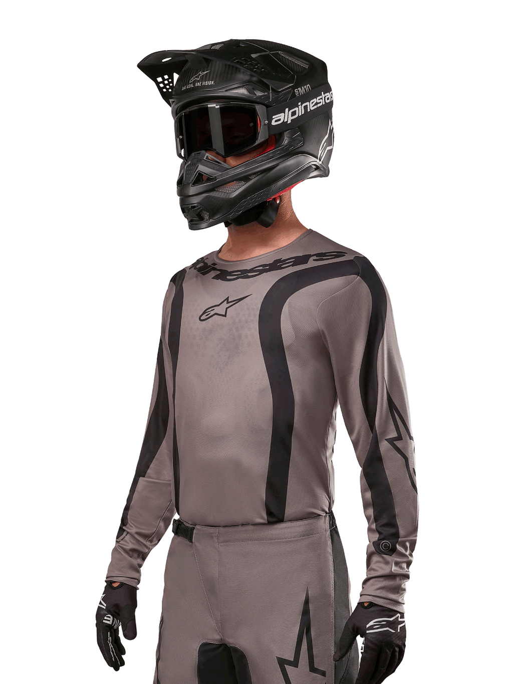 Alpinestars 2024 Fluid Lurv Jersey, jersey de motocross, negro y gris, diseño de manga larga con rayas negras curvas y logotipos, usado con pantalones a juego y un casco de motocross negro, conjunto coordinado para carreras off-road