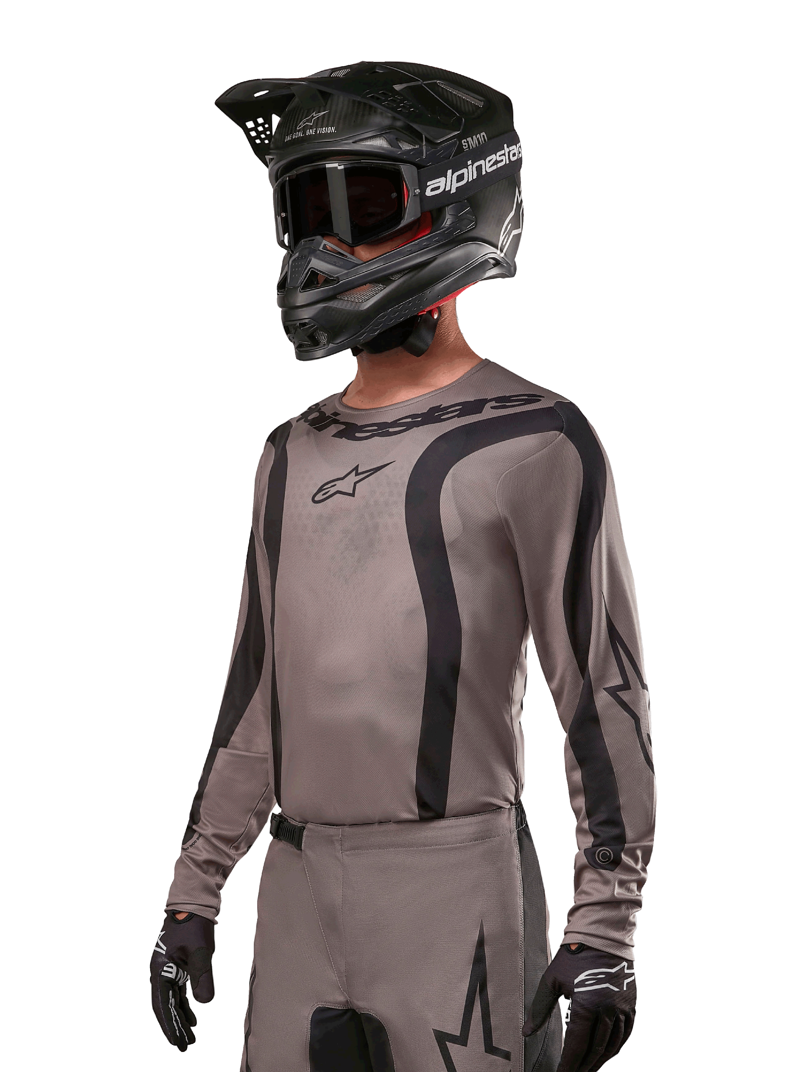 Alpinestars 2024 Fluid Lurv Jersey, jersey de motocross, negro y gris, diseño de manga larga con rayas negras curvas y logotipos, usado con pantalones a juego y un casco de motocross negro, conjunto coordinado para carreras off-road