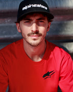 Alpinestars Formulate Csf Tee en rojo, Francesco Bagnaia con camiseta de manga corta con el logo Astars en negro y gorra de béisbol negra, estilo casual de motorsport