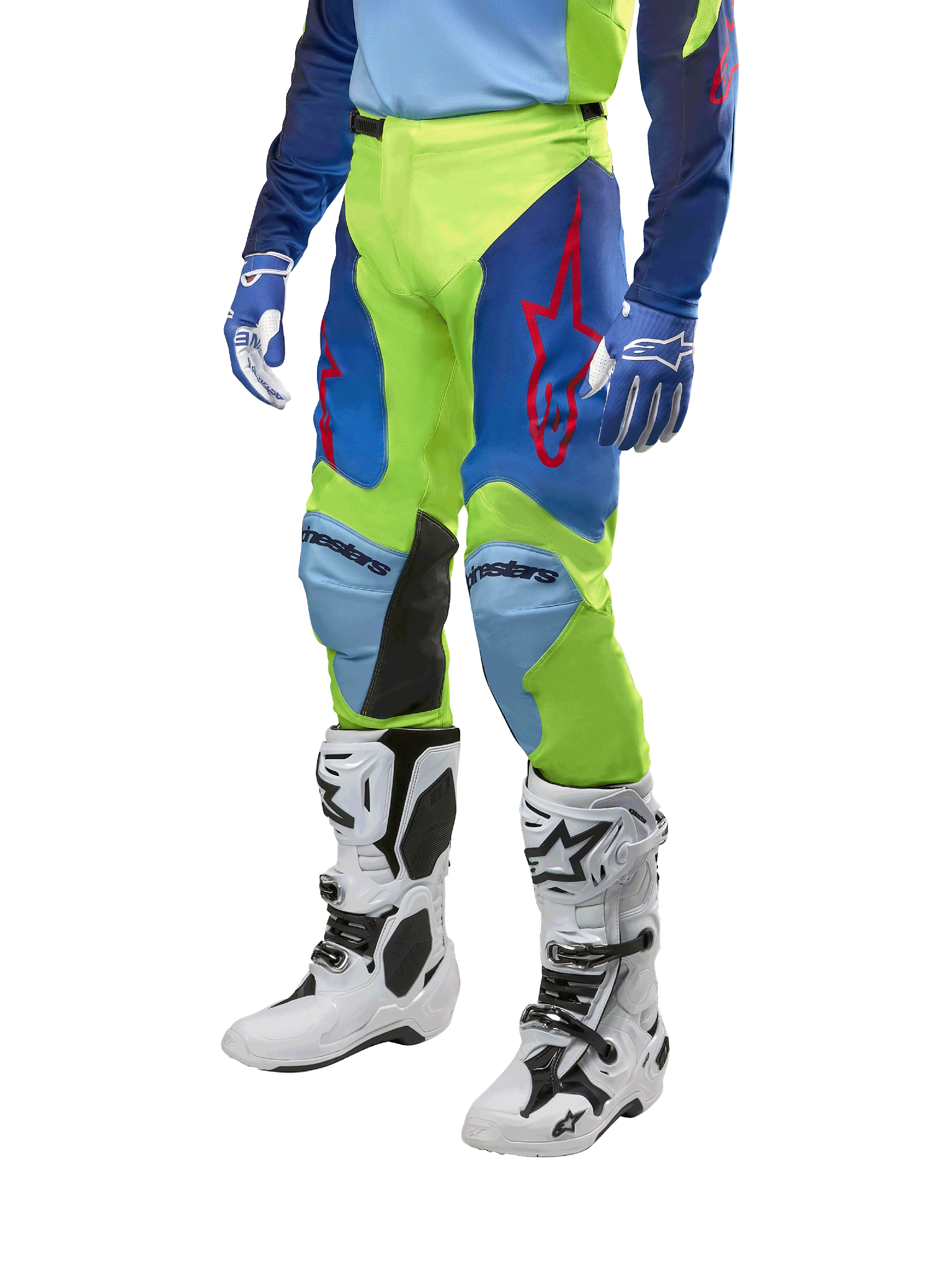 Alpinestars Racer Hoen Pants 2024, pantalones de motocross, amarillo flúor y azul noche navy, con logotipos de estrellas rojas y paneles internos negros en las rodillas, usados con jersey a juego y botas de motocross blancas, equipo de alto rendimiento para carreras todoterreno
