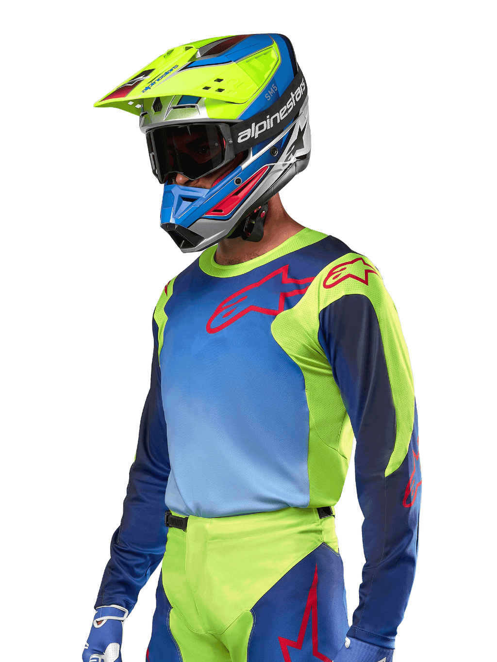 Jersey Alpinestars Racer Hoen 2024, camiseta de motocross, en color amarillo flúor y azul Night Navy con logos rojos, combinada con un casco a juego en amarillo, azul y rojo y guantes azules; equipamiento vibrante para carreras off-road