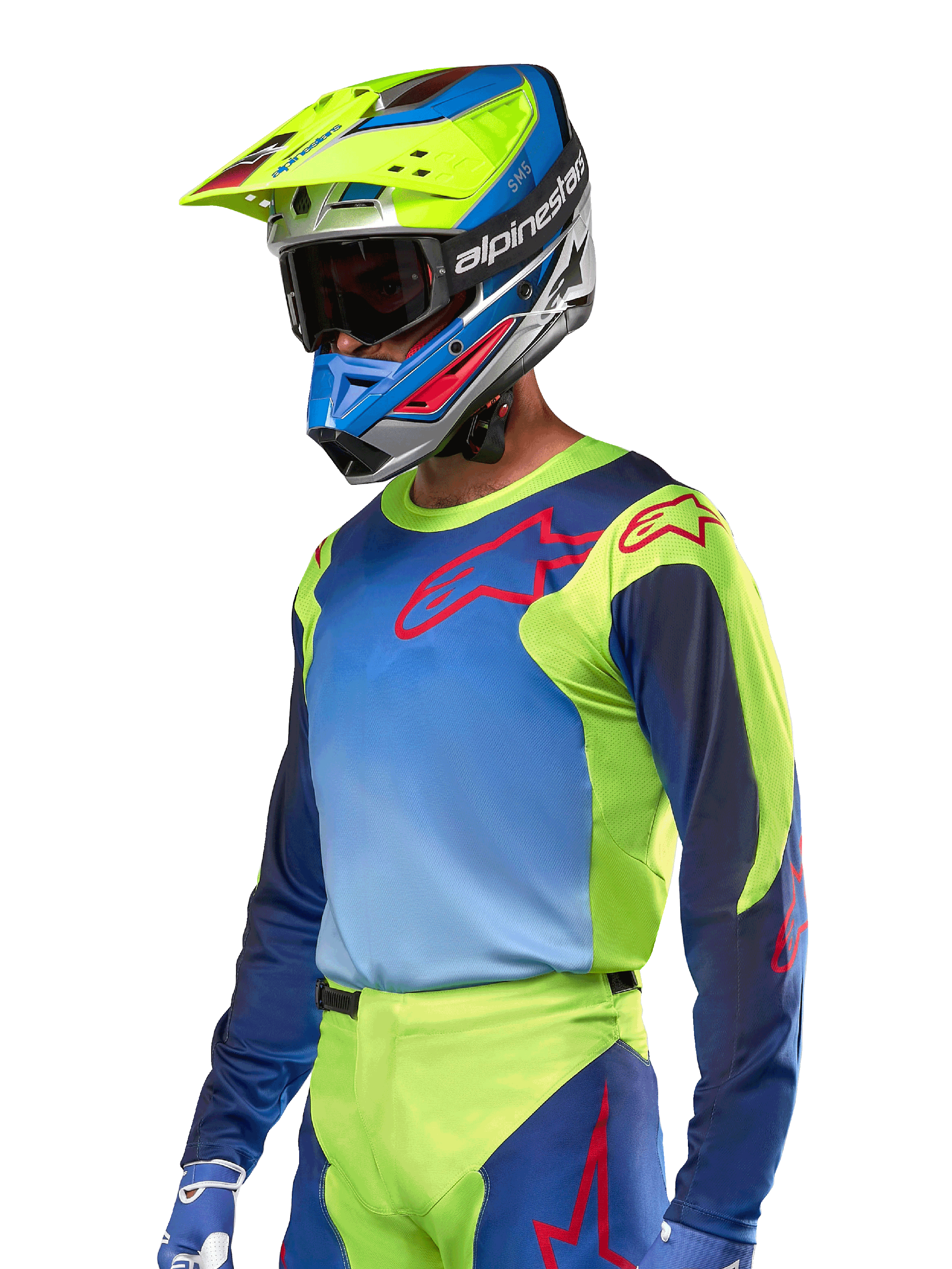 Jersey Alpinestars Racer Hoen 2024, camiseta de motocross, en color amarillo flúor y azul Night Navy con logos rojos, combinada con un casco a juego en amarillo, azul y rojo y guantes azules; equipamiento vibrante para carreras off-road