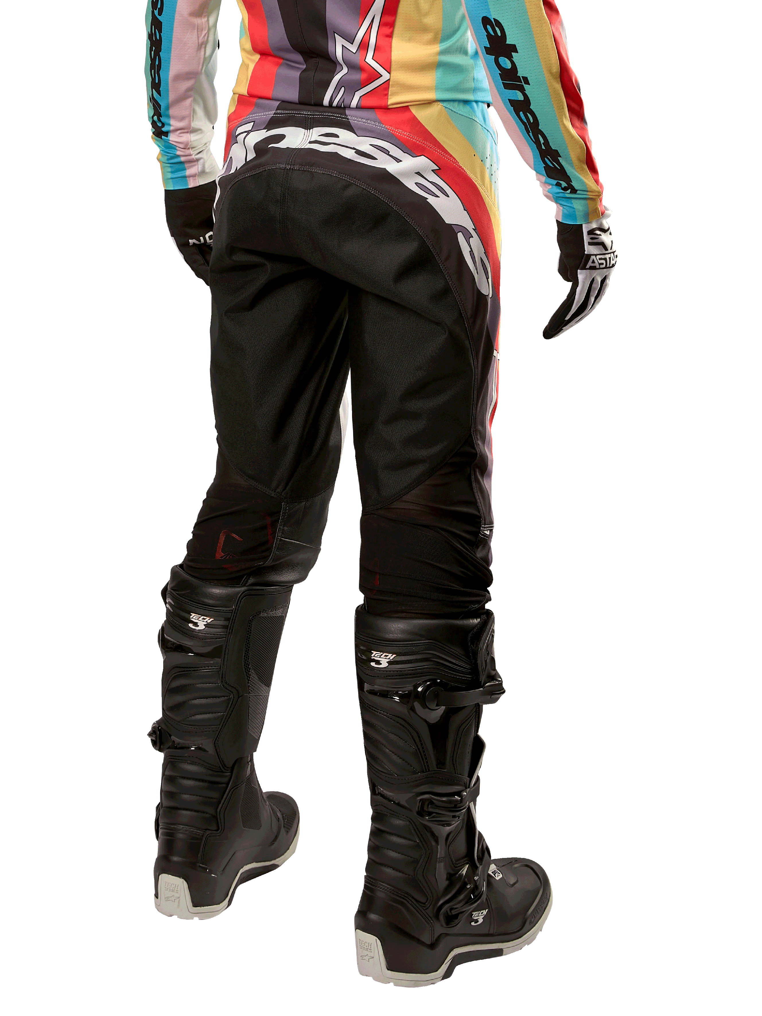 Alpinestars Stella Techstar Pants 2024 para mujer, pantalones de motocross, negro multicolor, vista trasera con marca blanca destacada en el asiento, combinados con botas Tech 3 negras y un jersey multicolor a juego, equipamiento profesional de carreras todoterreno