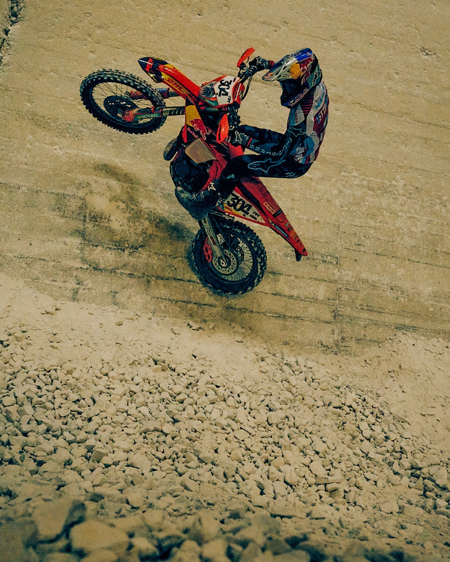 Alpinestars Techstar Beast Coast Gear Set AND S-M7 Beast Coast Helmet, men's black and orange motocross wheelie.