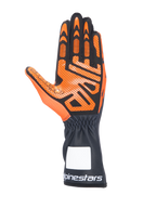 Guantes de karting Alpinestars Tech-1 K V3, negro y naranja, vista de la palma con patrón detallado de agarre de silicona, puño largo con logotipo blanco de Alpinestars, diseño ergonómico para carreras de karts
