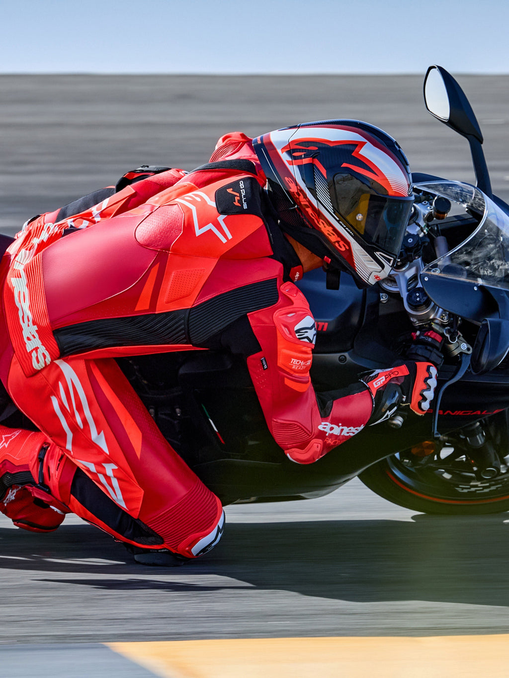 Alpinestars GP Plus V4 Sprint 1PC Leather Suit, Red Fluo and White, Tech-Air ready racing suit on rider in track turn.