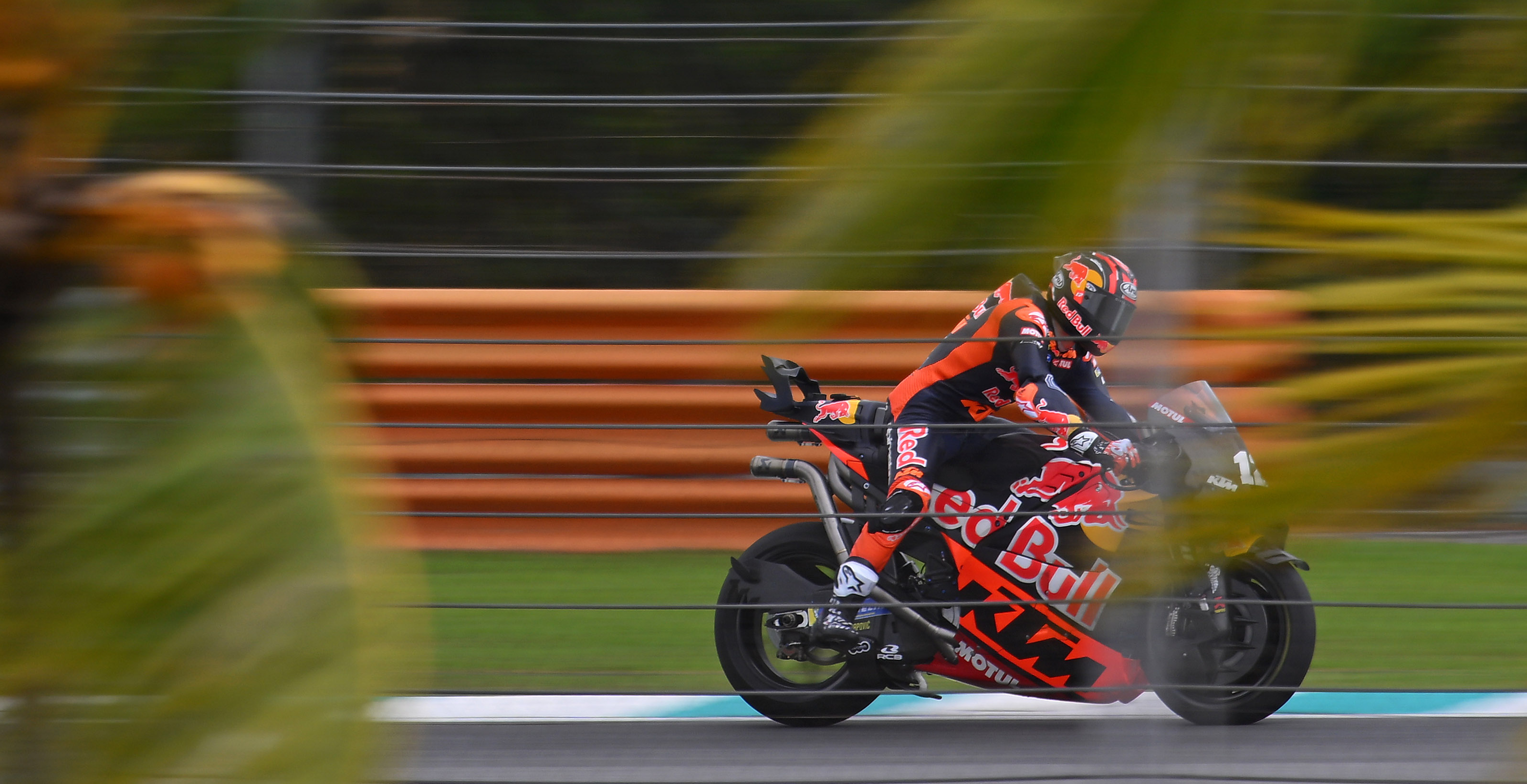 Maverick Vinales in action on a track with blurred background, wearing Alpinestars gear