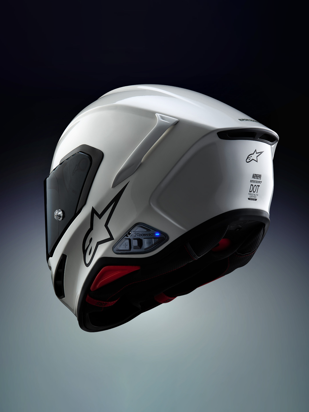 Sistema de comunicación Alpinestars A-Connect instalado en un casco de moto Alpinestars S-R7, blanco y negro, con intercomunicador Mesh 3.0 y unidad de control Bluetooth 5.3 con luz LED azul activa