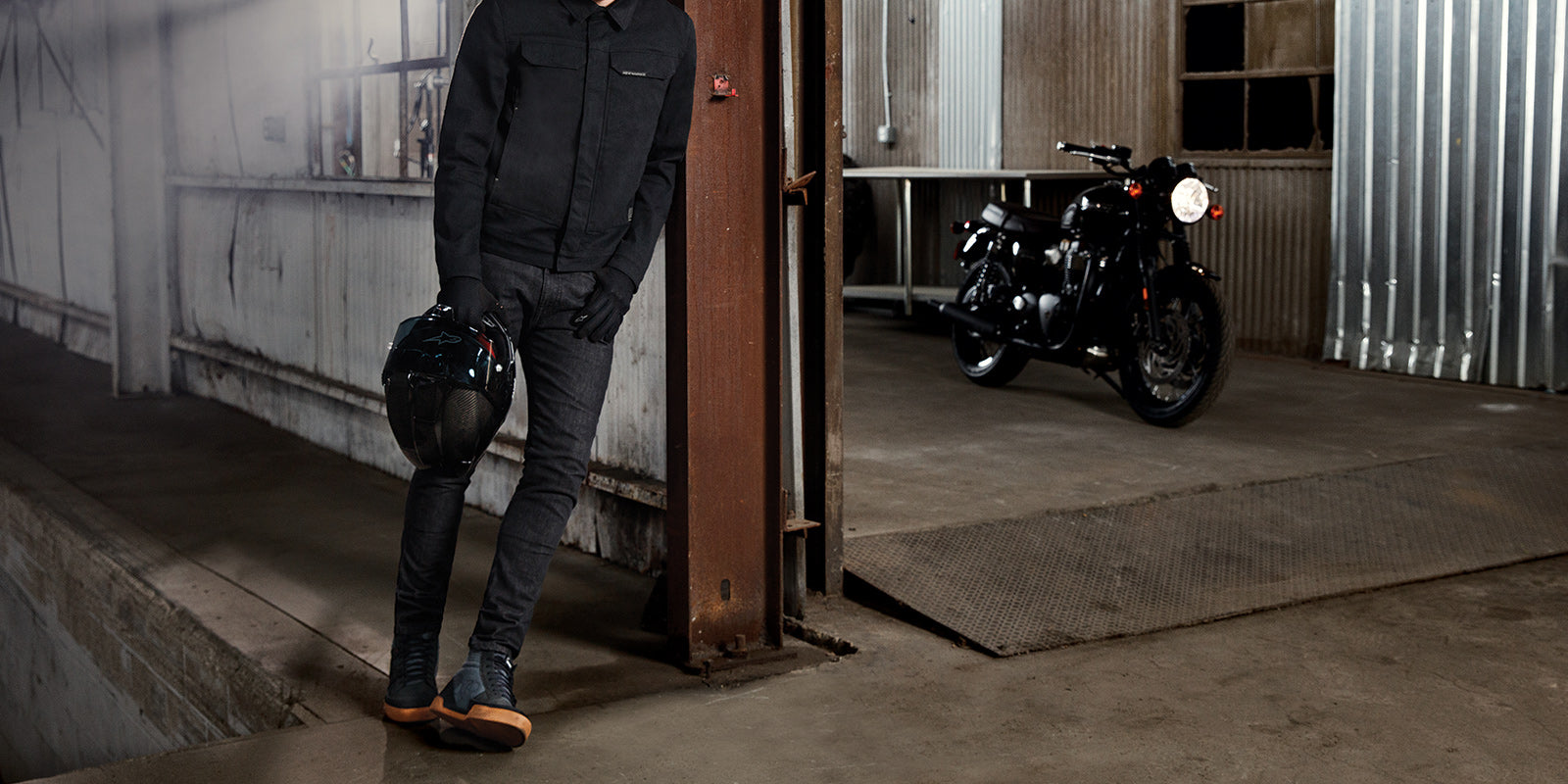 Alpinestars Garage Jacket, men's urban motorcycle denim jacket in Smoke Gray, shown on-model in an industrial garage.