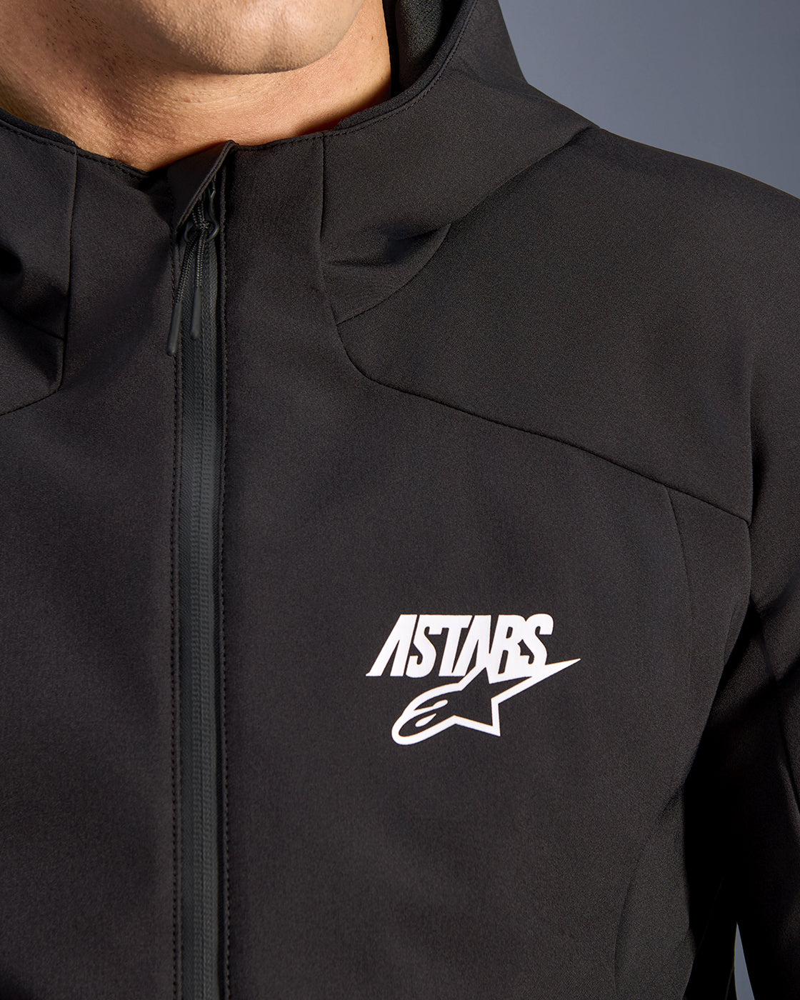Alpinestars Aeroshell Waterproof Jacket, men's black softshell motorcycle jacket with white logo and taped front zipper.